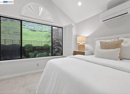 a spacious bedroom with a bed and a table in it