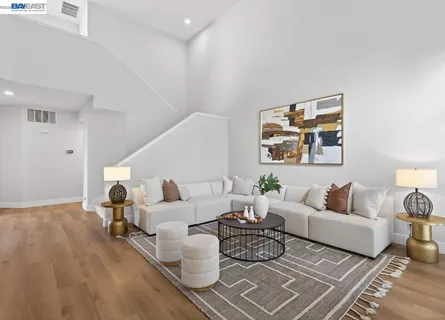 a living room with furniture a fireplace and a potted plant