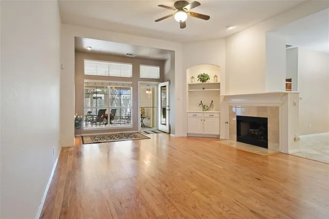 a view of a livingroom with wooden floor and a kitchen space