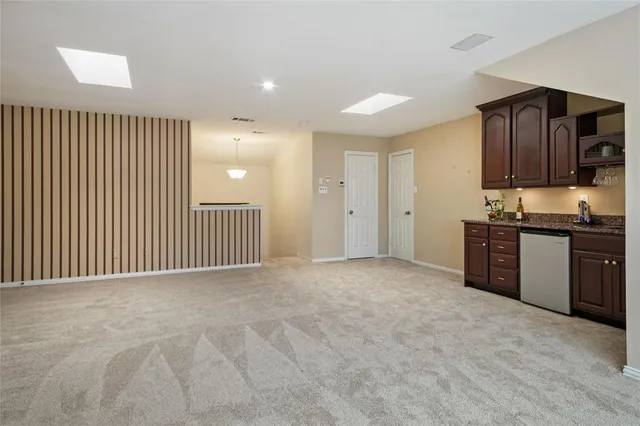 a spacious bedroom with a bed and large windows