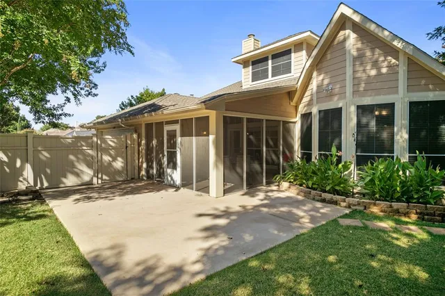 a view of a backyard with a large tree