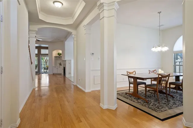 a view of a dining room with furniture and chandelier