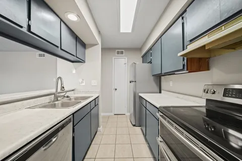 a kitchen with a sink appliances and cabinets