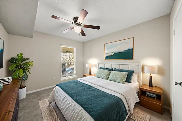 a bedroom with a bed and a potted plant