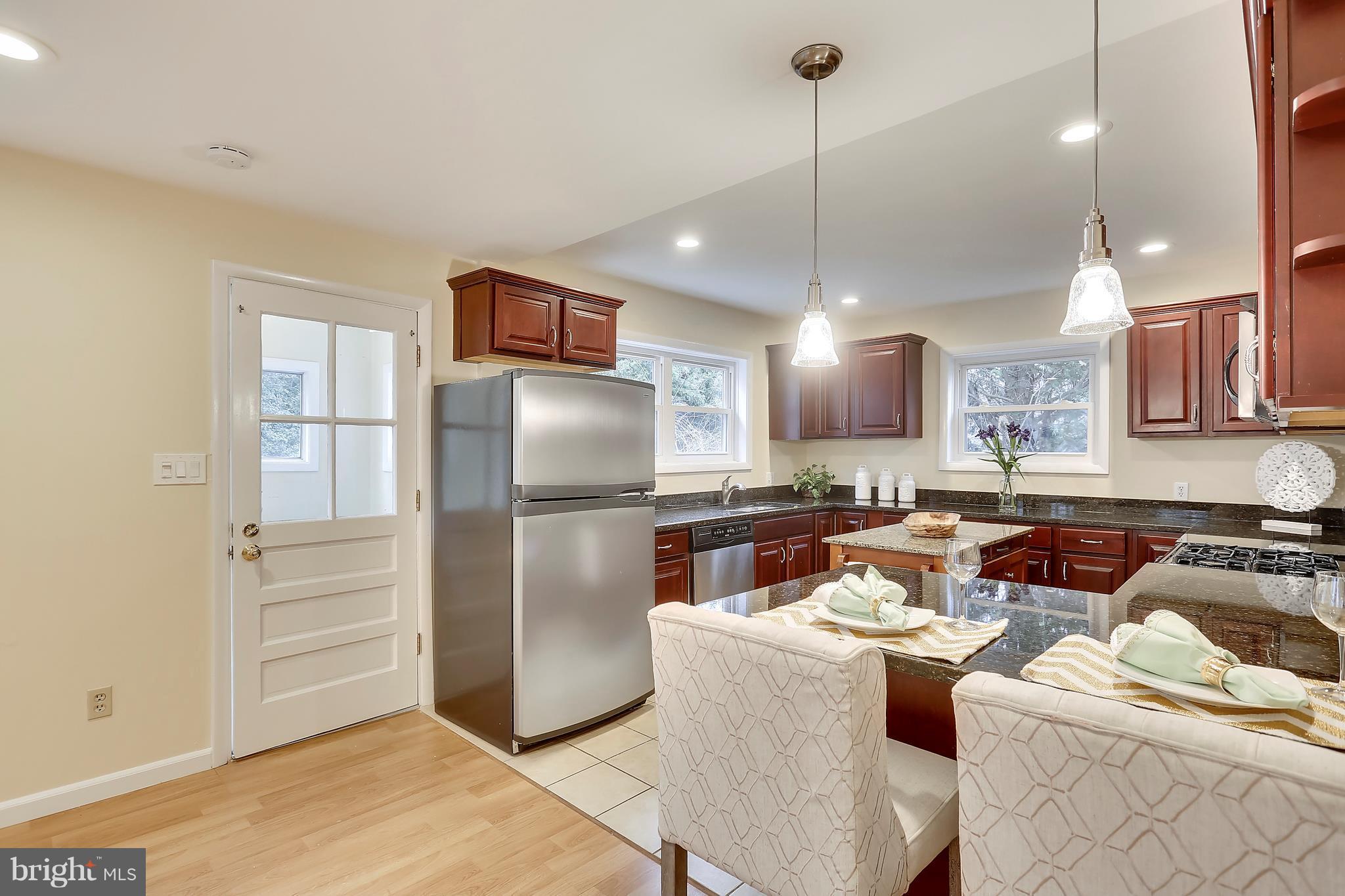 4717 Oxbow Road Rockville, MD 20852 - Photo 17 of 30 Kitchen with breakfast bar and pendant lights.
