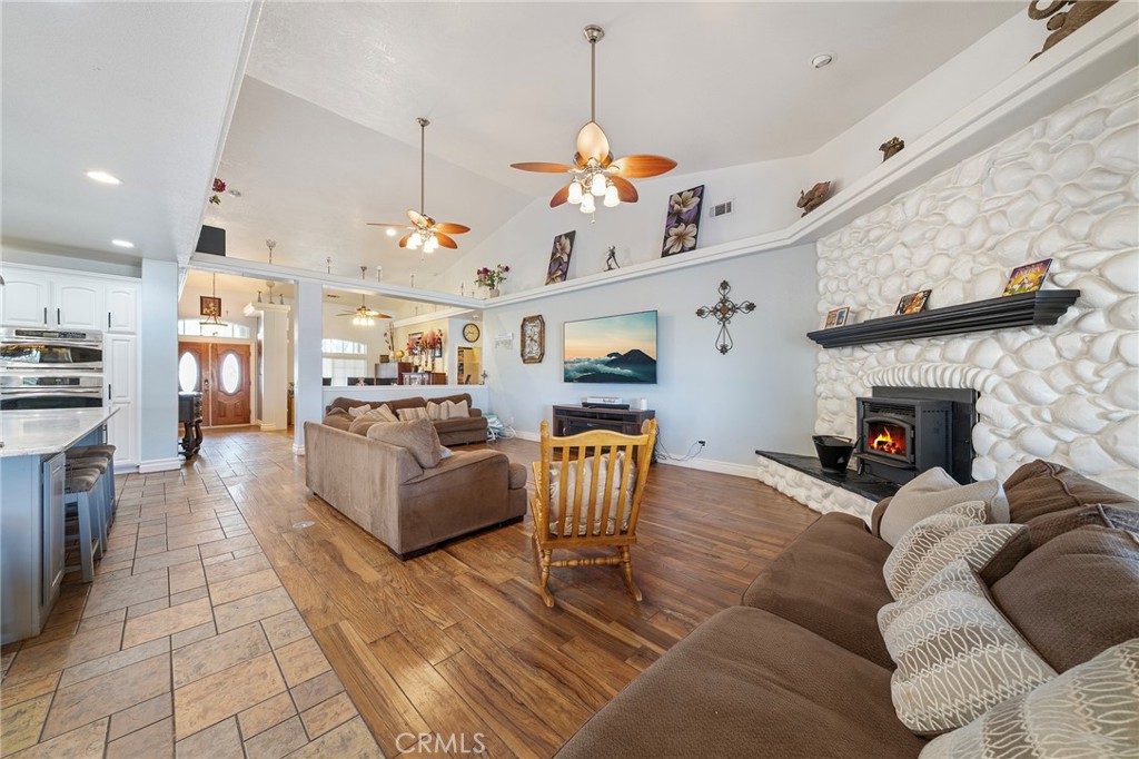 7172 Jargon Road Hesperia, CA 92344 - Photo 13 of 75 a living room with furniture a fireplace and a chandelier