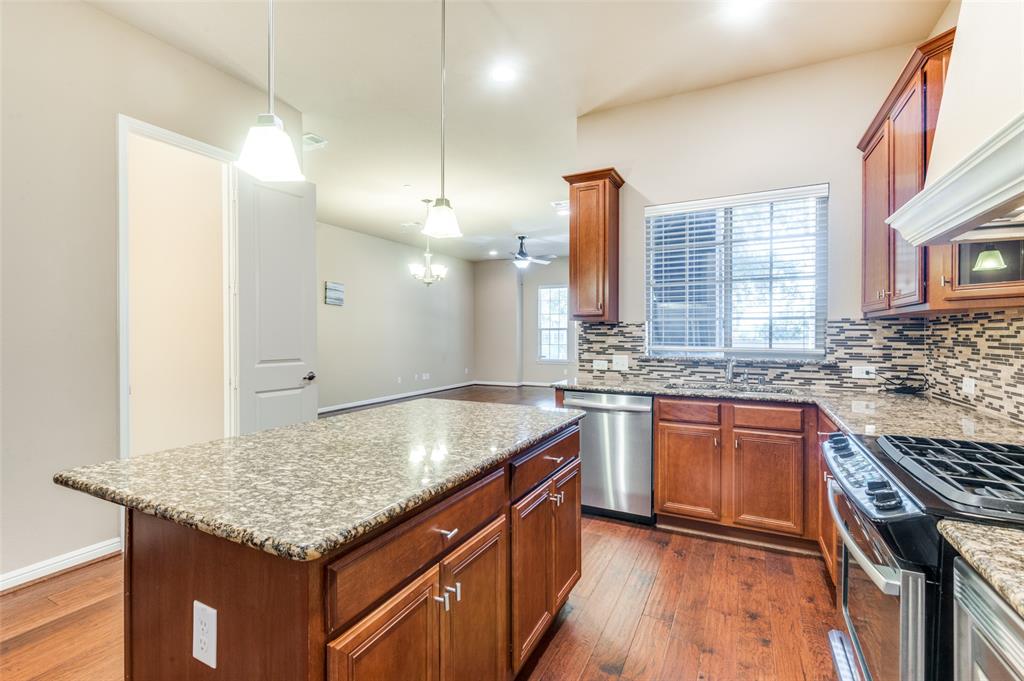 1915 Luther Road Irving, TX 75063 - Photo 11 of 25 a kitchen with stainless steel appliances granite countertop stove top oven and cabinets