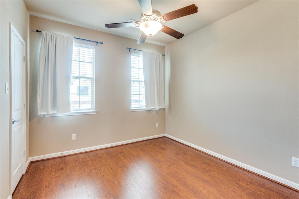 1915 Luther Road Irving, TX 75063 - Photo 18 of 25 an empty room with wooden floor and windows