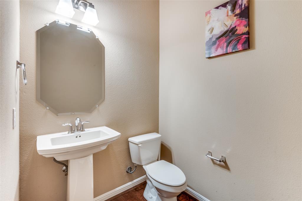 1915 Luther Road Irving, TX 75063 - Photo 24 of 25 a bathroom with a toilet sink and mirror