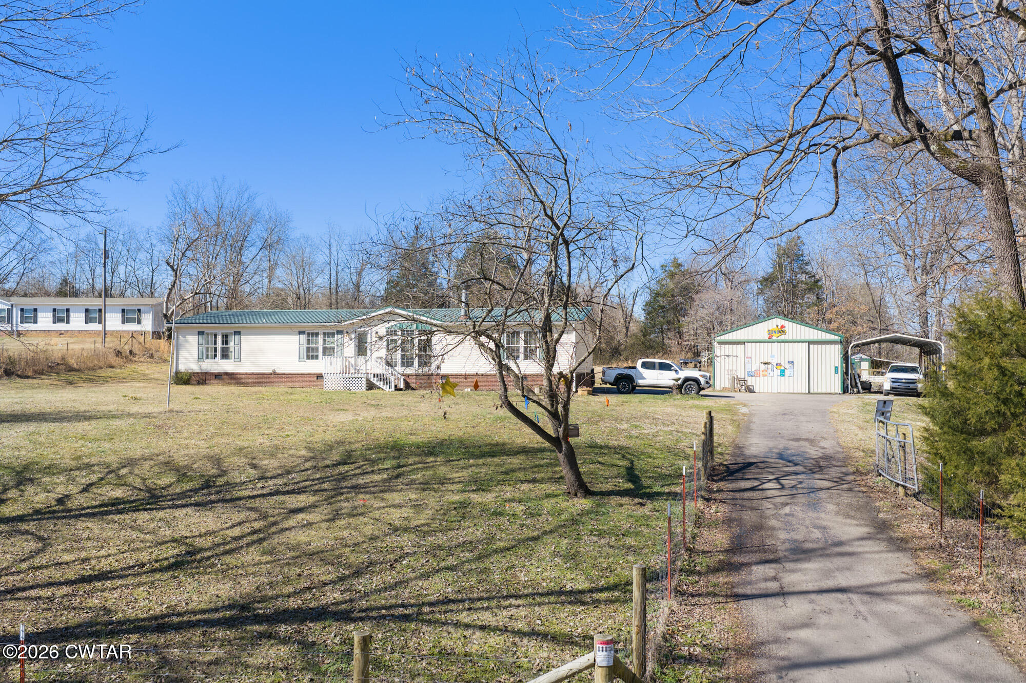a view of a yard with wooden fence