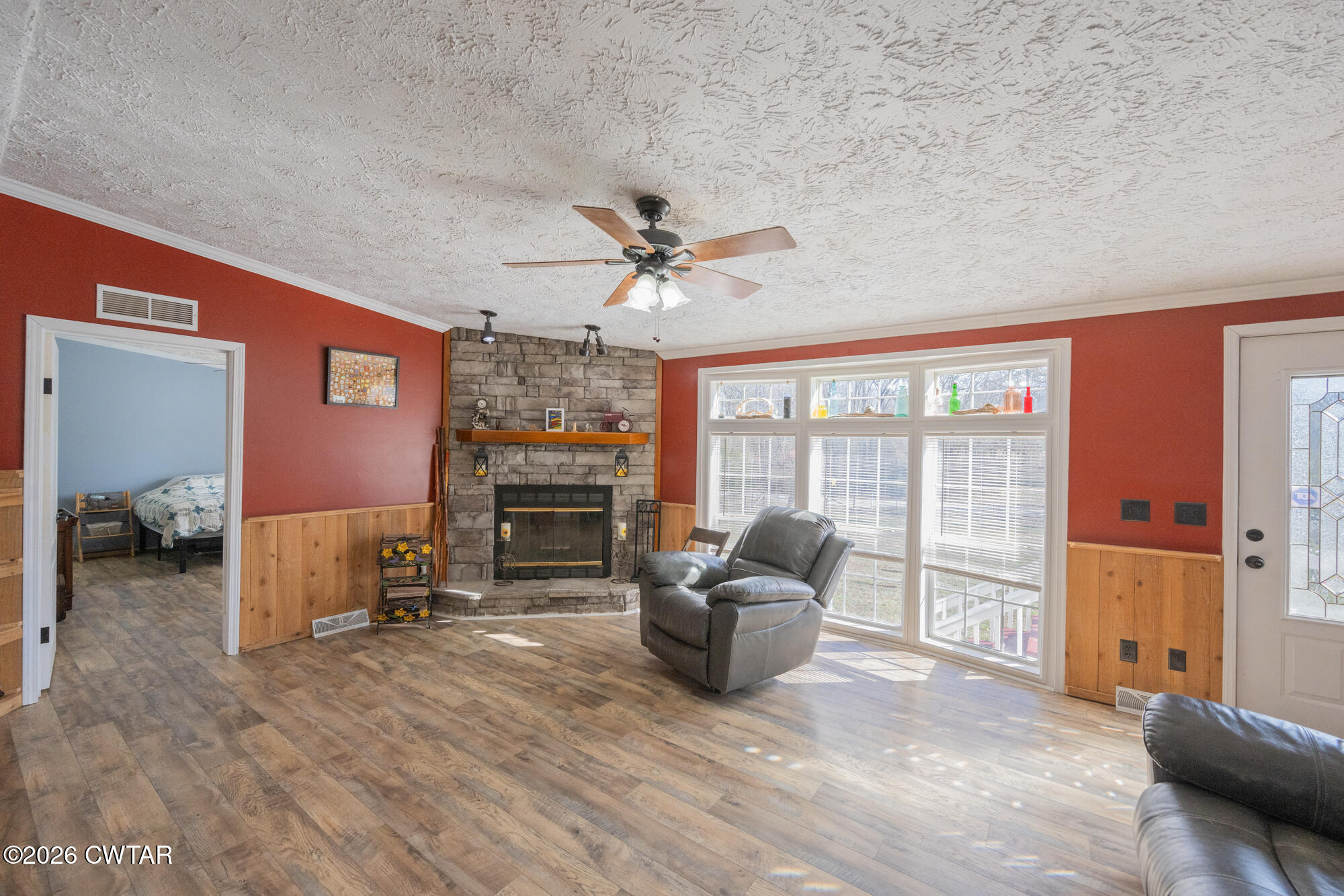 419 Hughes Road East Jackson, TN 38305 - Photo 13 of 39 a living room with furniture a fireplace and a large window
