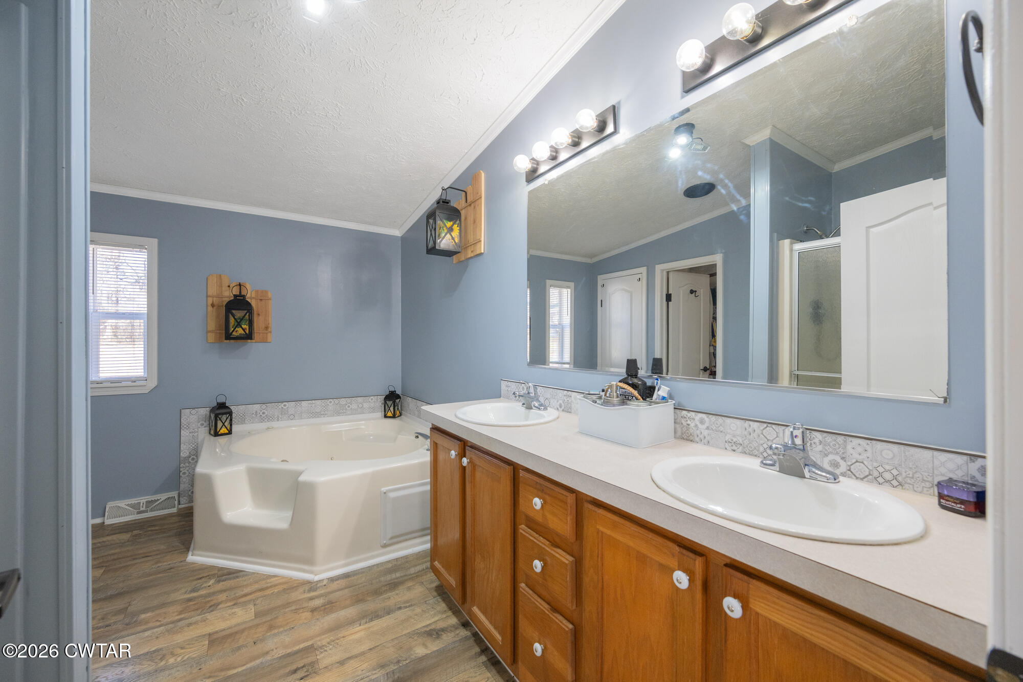419 Hughes Road East Jackson, TN 38305 - Photo 23 of 39 a bathroom with a double vanity sink a mirror and a bathtub
