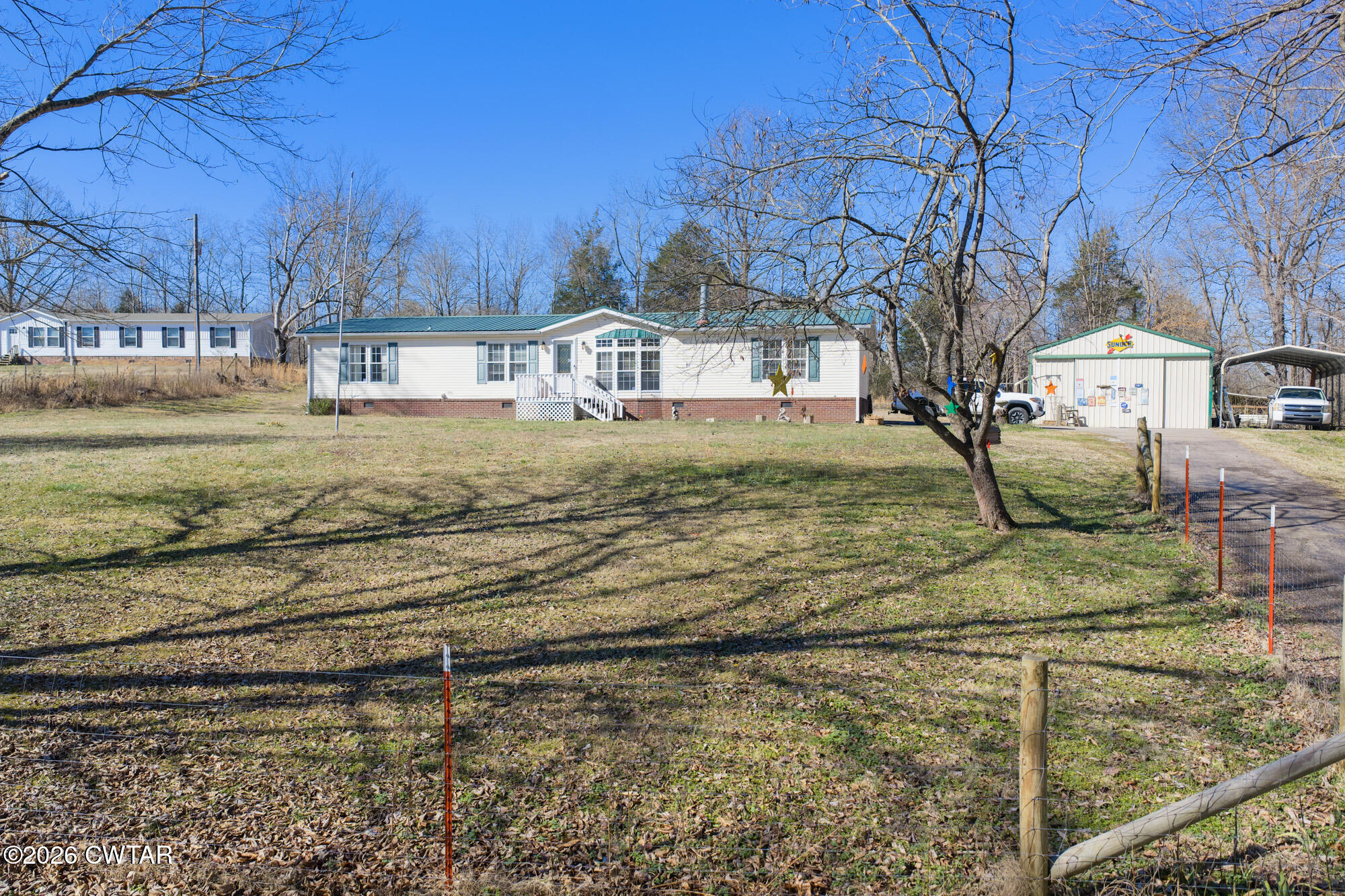 419 Hughes Road East Jackson, TN 38305 - Photo 4 of 39 a view of a yard with large trees