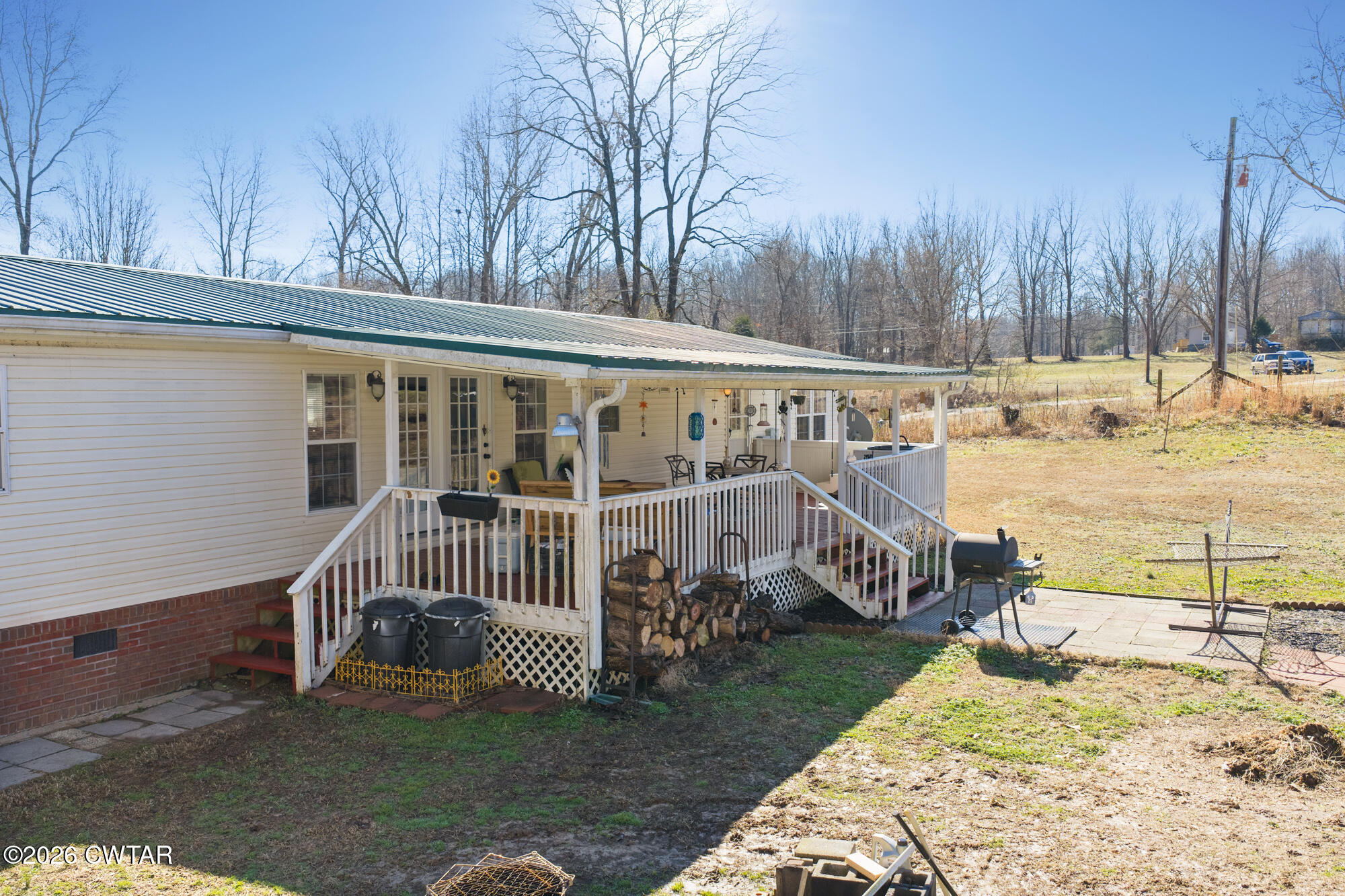 419 Hughes Road East Jackson, TN 38305 - Photo 8 of 39 a view of a house with a wooden deck and a yard