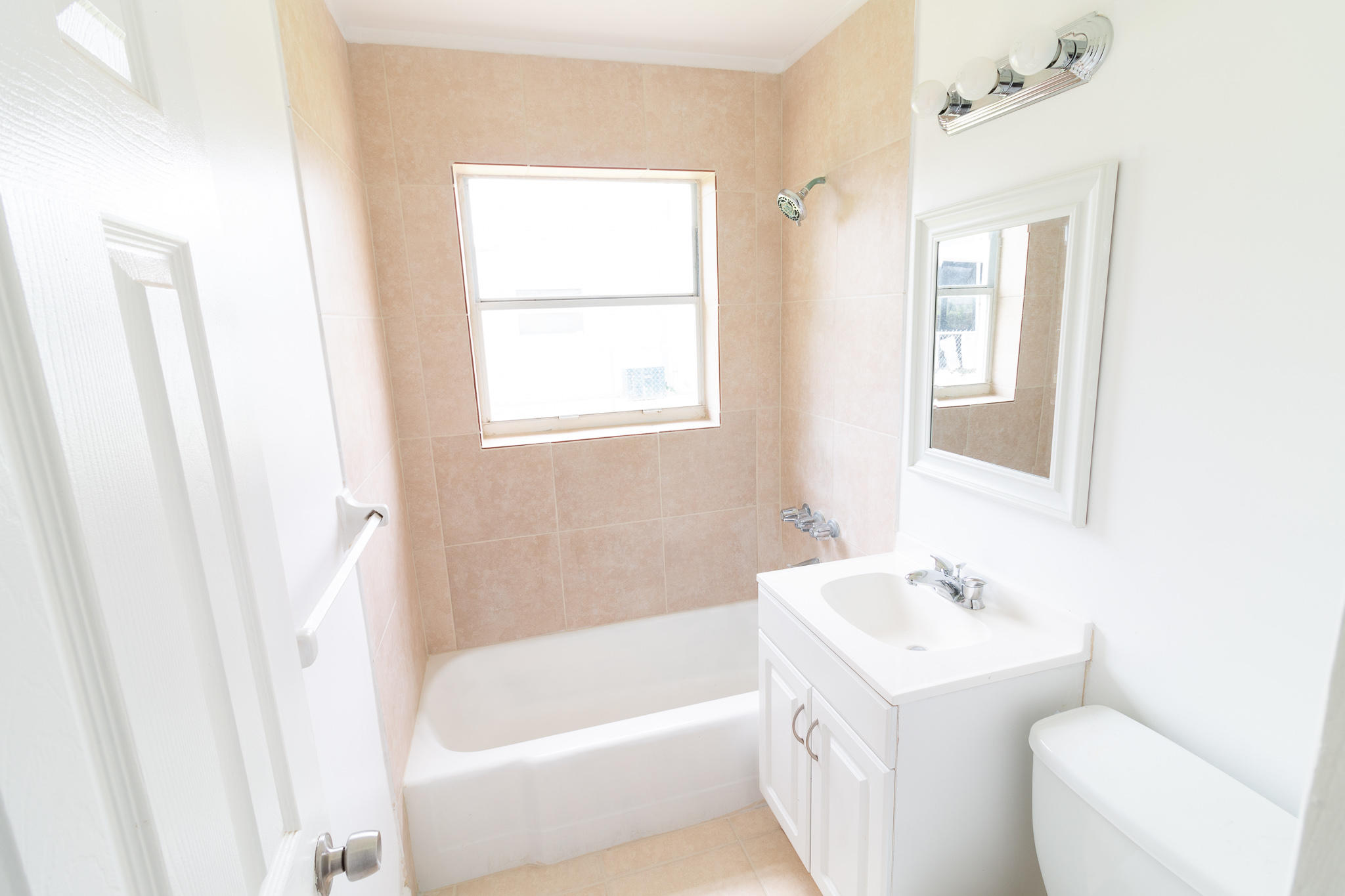 1031 West 3rd Street Riviera Beach, FL 33404 - Photo 5 of 11 a bathroom with a sink a toilet and a bathtub
