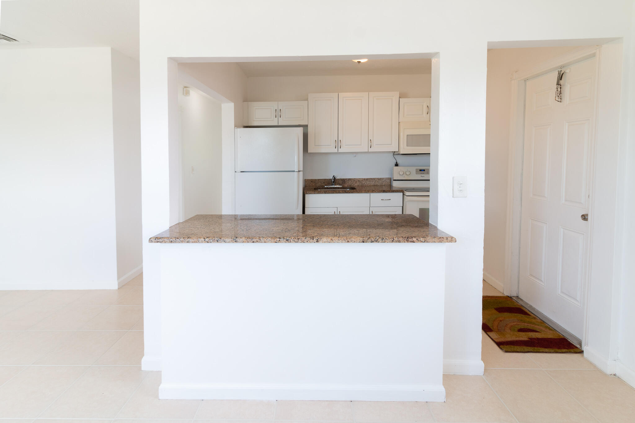 1031 West 3rd Street Riviera Beach, FL 33404 - Photo 8 of 11 a kitchen with a refrigerator and a stove
