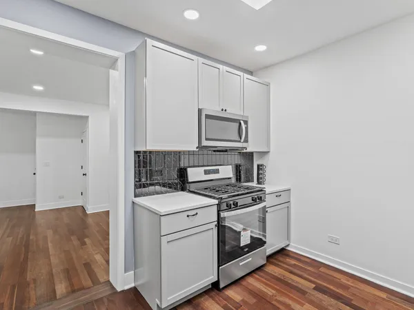 a kitchen with a stove microwave and sink