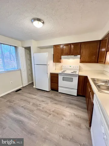 a kitchen with a refrigerator and a stove