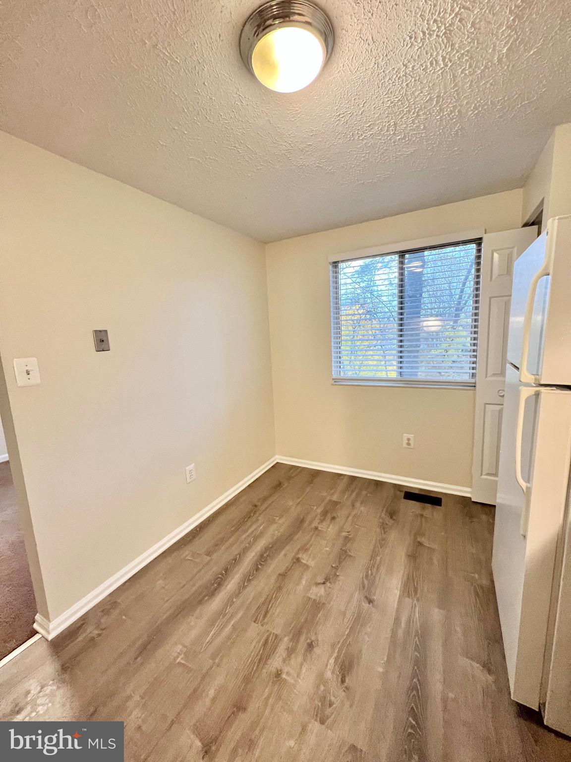 10129 Shelldrake Circle Damascus, MD 20872 - Photo 16 of 39 an empty room with wooden floor and windows
