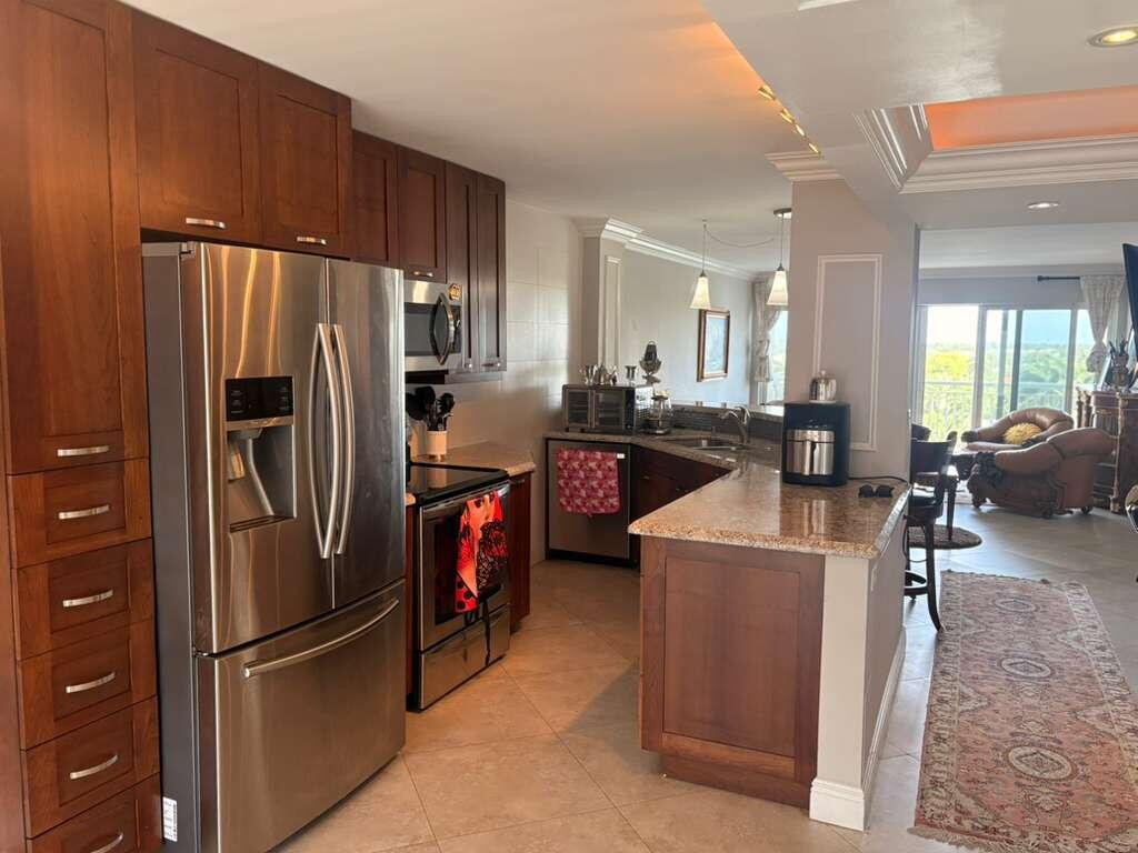 2611 North Riverside Drive, Unit 703 Pompano Beach, FL 33062 - Photo 6 of 81 a kitchen with stainless steel appliances granite countertop a refrigerator a stove a sink and a refrigerator
