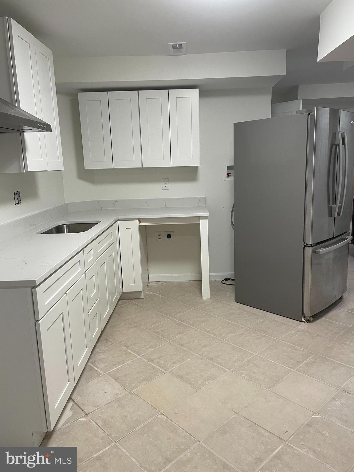 8018 Sinclair Mill Road Manassas, VA 20112 - Photo 2 of 10 a kitchen with white cabinets and refrigerator