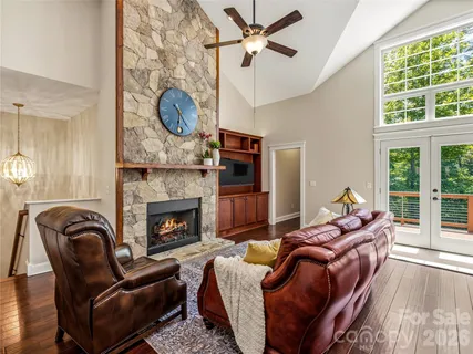 a living room with furniture a fireplace and a large window