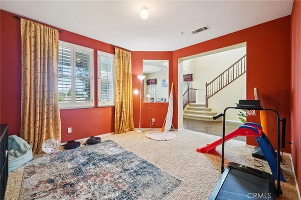 a bedroom with a bed and large windows