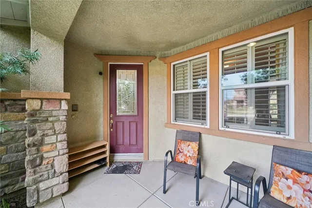 a front view of a house with outdoor seating