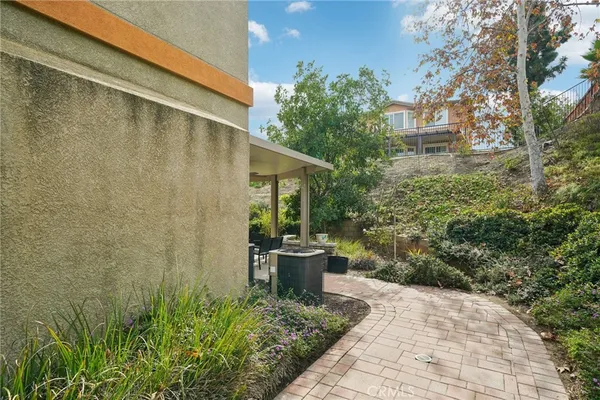 a patio with yard and outdoor seating