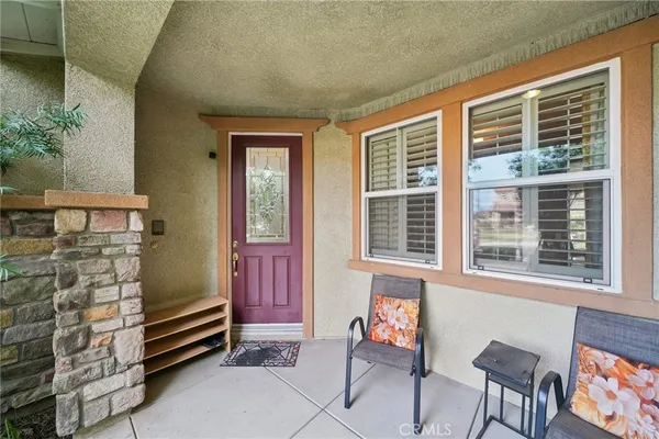 a front view of a house with outdoor seating