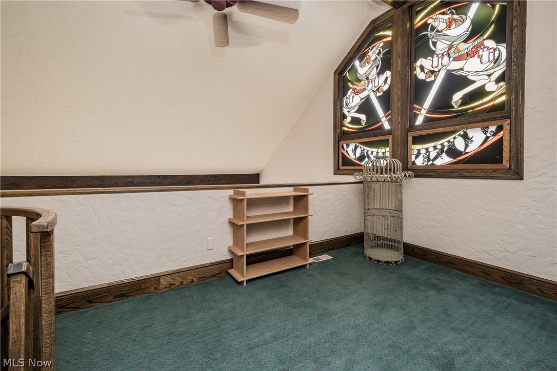 1415 Harbor Drive Northwest Canton, OH 44708 - Photo 33 of 46 Loft overlooking Owners Bedroom with carpet floors, ceiling fan, and vaulted ceiling