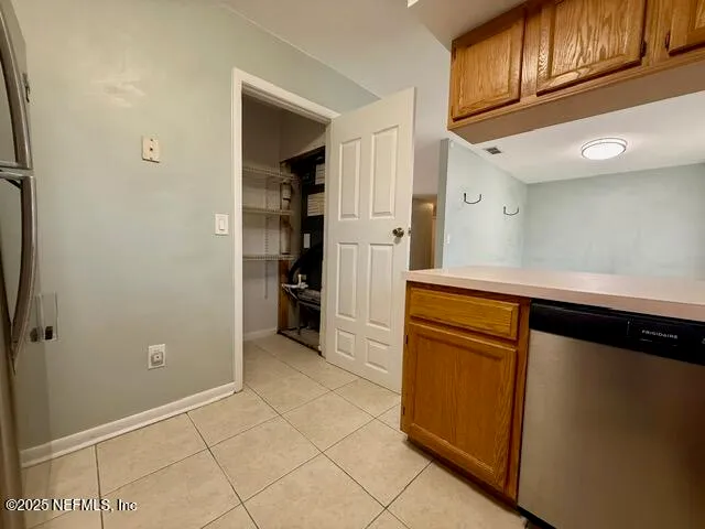 a kitchen with cabinets and a refrigerator