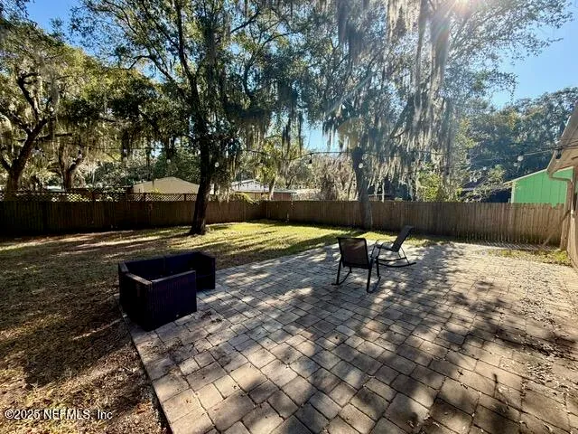 a view of a bench with wooden fence