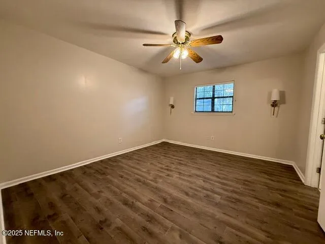 an empty room with fan and a ceiling fan