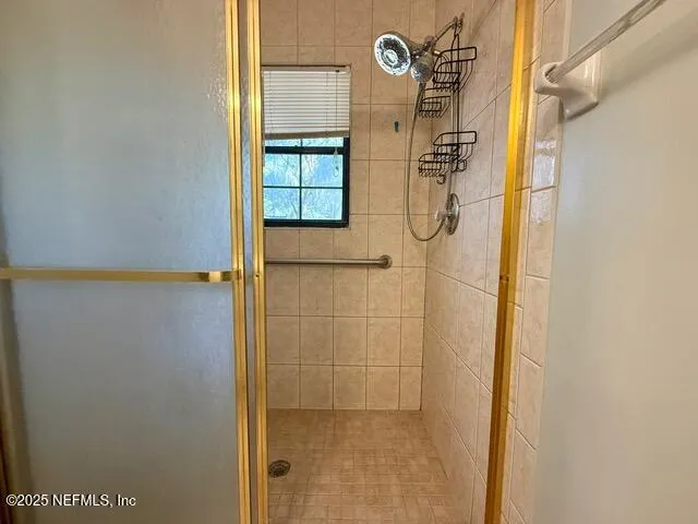 a bathroom with a glass shower door
