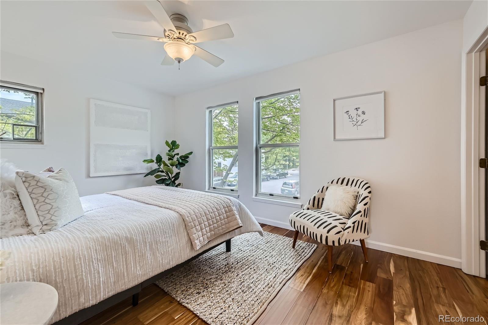 1150 Inca Street, Unit 74 Denver, CO 80204 - Photo 13 of 32 a bedroom with a bed and a couch