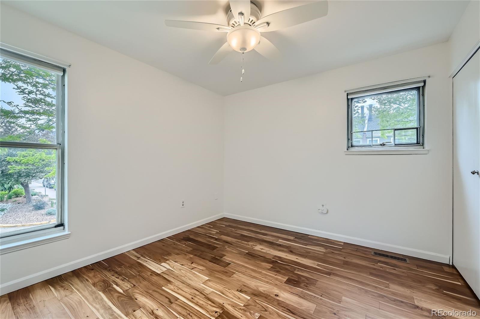 1150 Inca Street, Unit 74 Denver, CO 80204 - Photo 16 of 32 an empty room with a window and ceiling fan