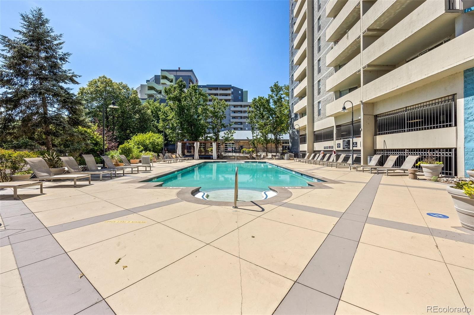 1150 Inca Street, Unit 74 Denver, CO 80204 - Photo 25 of 32 a swimming pool with outdoor seating and yard