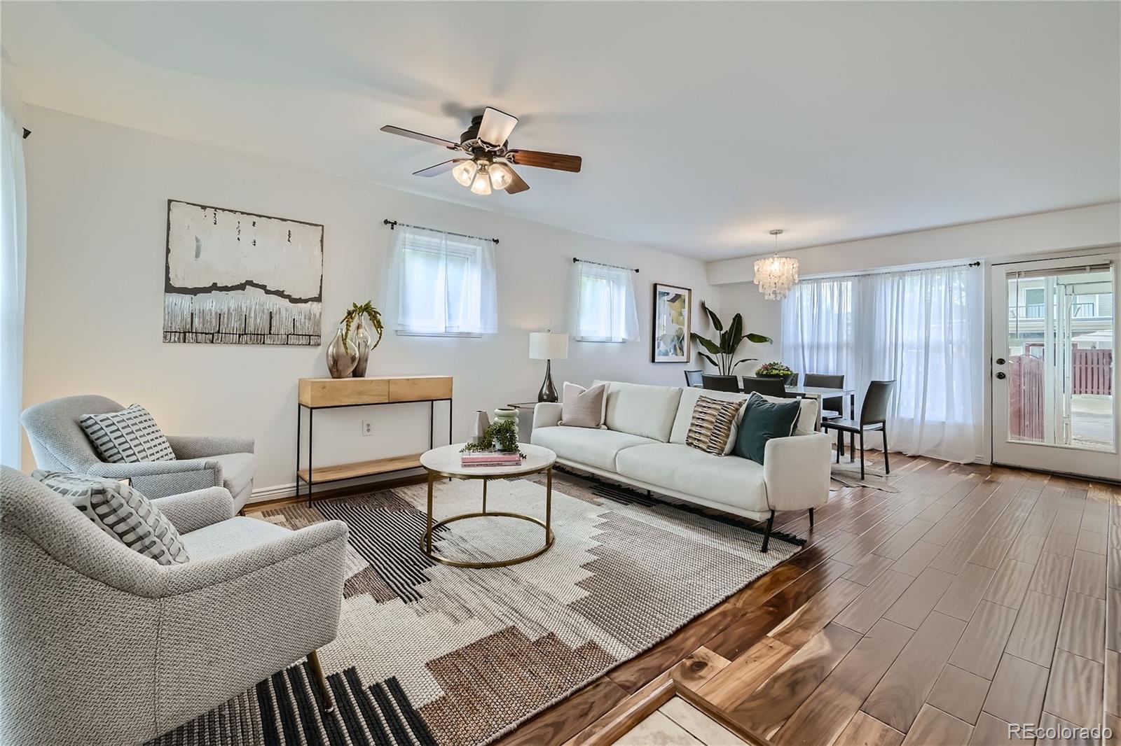 1150 Inca Street, Unit 74 Denver, CO 80204 - Photo 3 of 32 a living room with furniture and wooden floor
