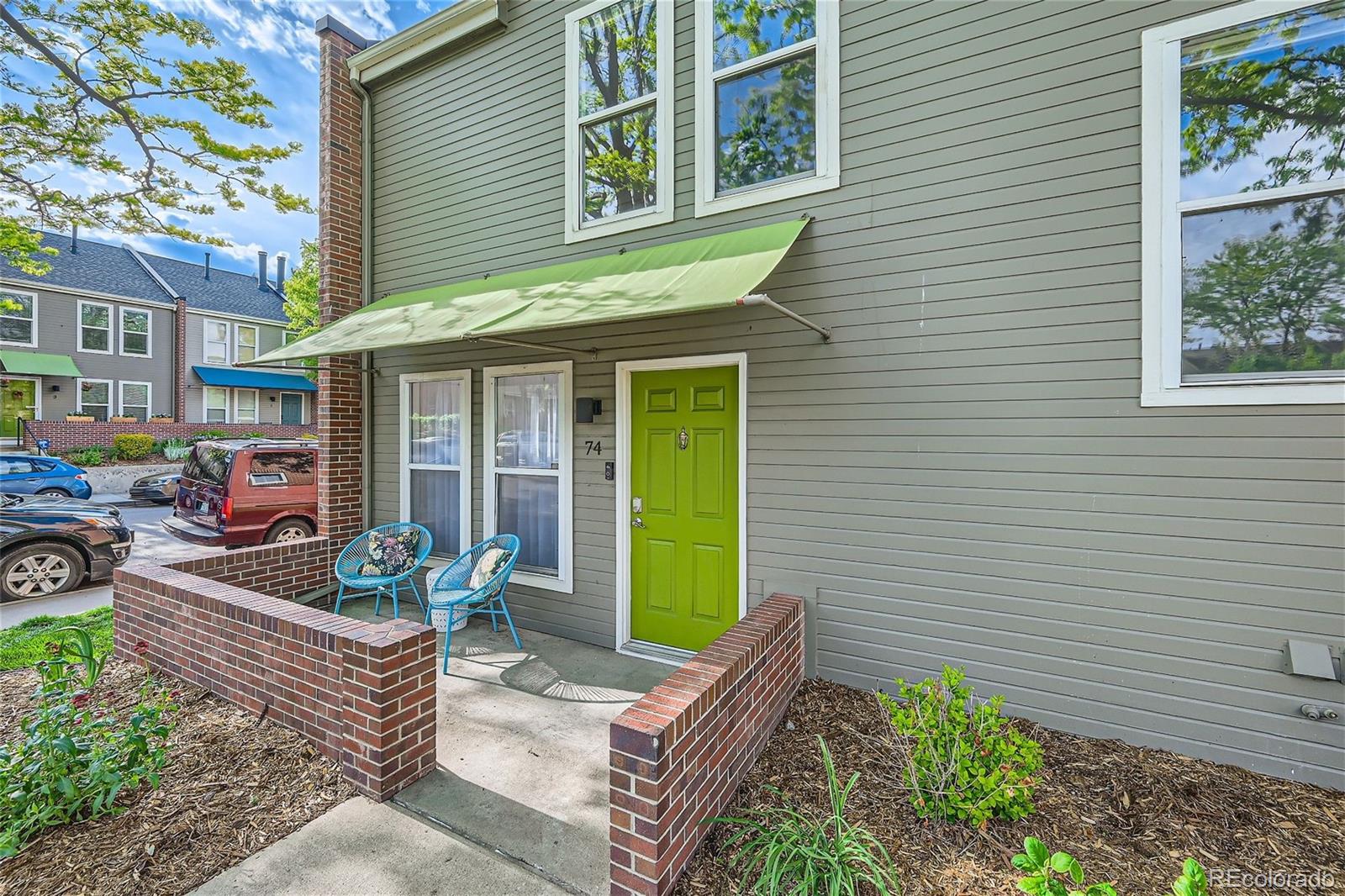 1150 Inca Street, Unit 74 Denver, CO 80204 - Photo 31 of 32 a front view of a house with garden and porch