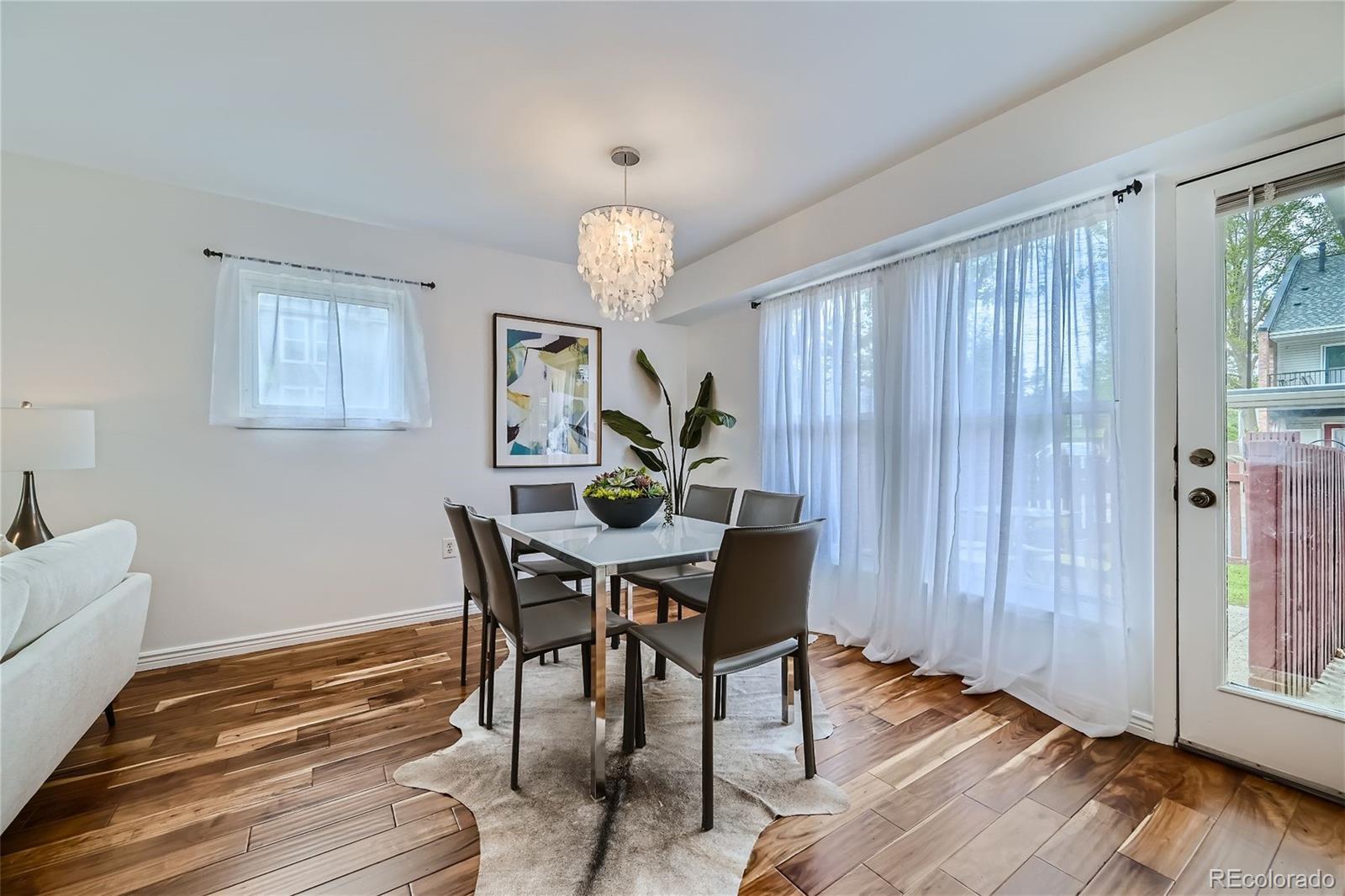 1150 Inca Street, Unit 74 Denver, CO 80204 - Photo 6 of 32 a view of a dining room with furniture and wooden floor