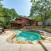 a swimming pool with outdoor seating and yard