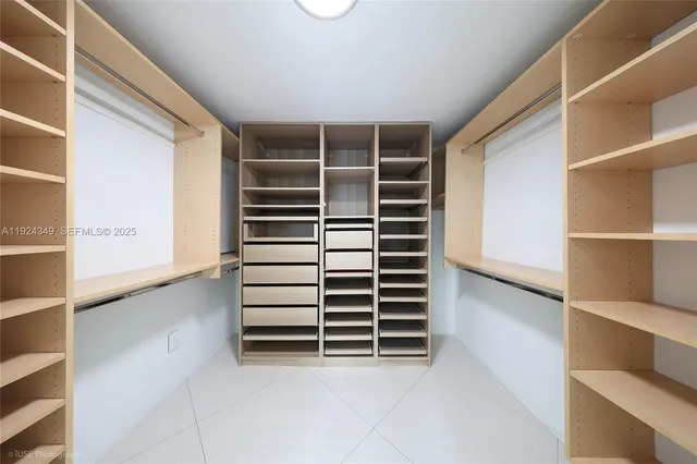 a view of walk in closet with empty racks