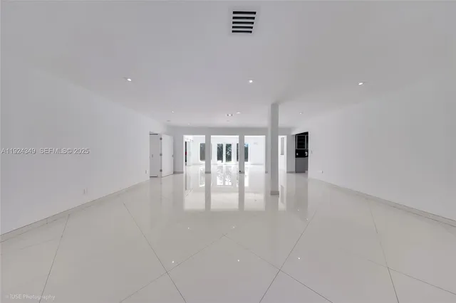 a view of an empty room with glass door