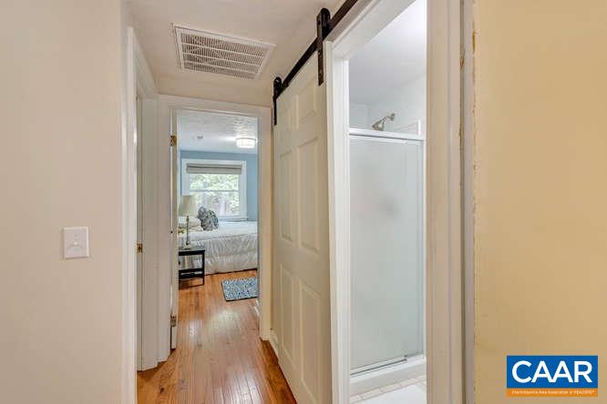 107 Goldenrod Road Ruckersville, VA 22968 - Photo 21 of 31 a view of a hallway with wooden floor windows and kitchen