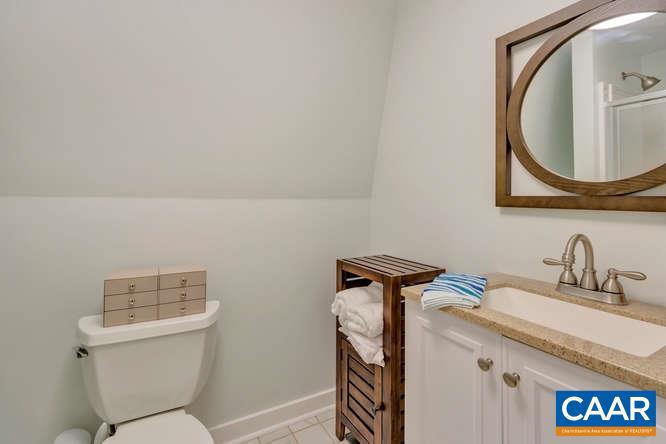 107 Goldenrod Road Ruckersville, VA 22968 - Photo 22 of 31 a bathroom with a granite countertop toilet sink and mirror