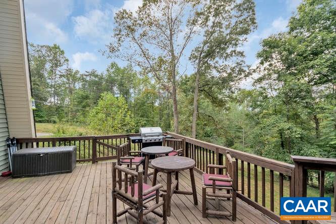 107 Goldenrod Road Ruckersville, VA 22968 - Photo 27 of 31 a view of a balcony with table and chairs and wooden floor