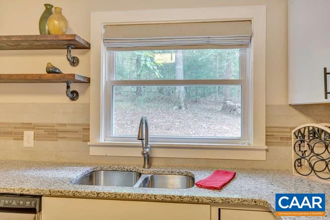 107 Goldenrod Road Ruckersville, VA 22968 - Photo 7 of 31 a kitchen with a granite countertop sink and cabinets
