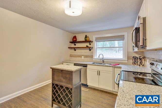 107 Goldenrod Road Ruckersville, VA 22968 - Photo 8 of 31 a kitchen with a sink a stove and cabinets