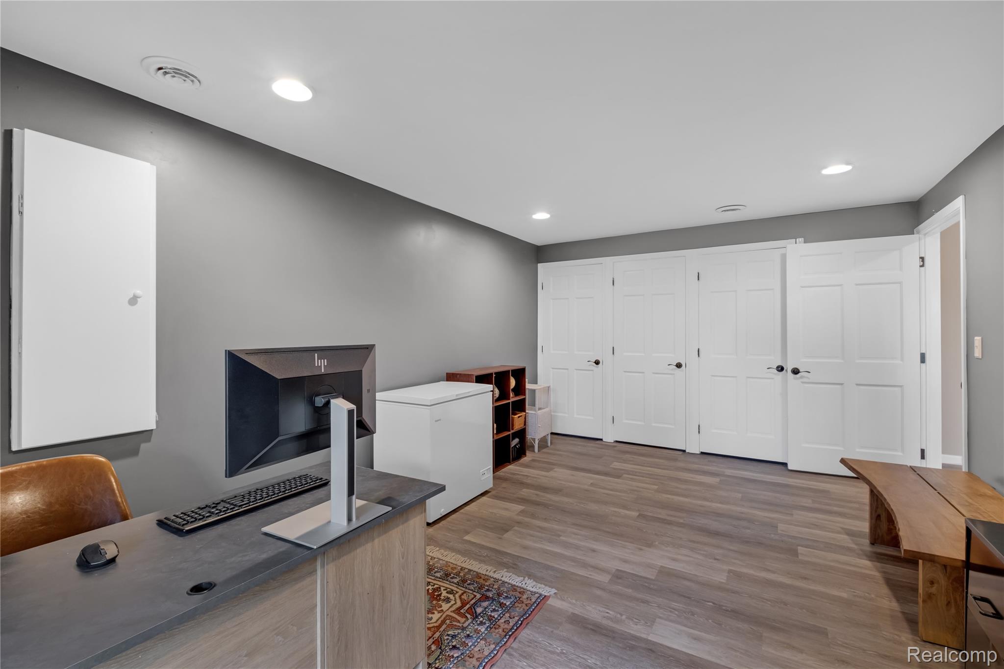 15420 Jennings Road Fenton, MI 48430 - Photo 30 of 45 Wide plank wood-finish flooring, recessed lighting, and multiple panel doors with dark hardware
